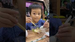 Kids eat salad with family