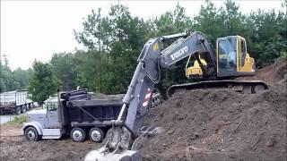 Volvo EC210 Excavator Rocking Out Trucks