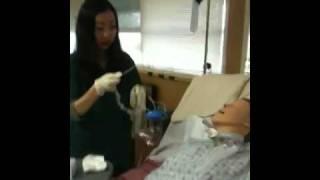 Catherine Poon suctioning a tracheostomy for a nursing skills lab class