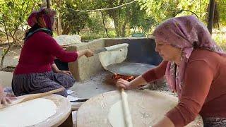 MAKING phyllo bread over a wood fire