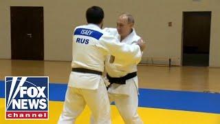 Putin trains with Russian judo champions