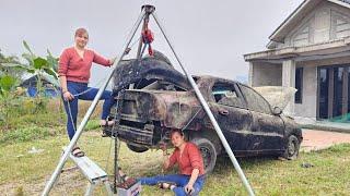 The girl repairs and maintains old cars that have been abandoned for a long time.