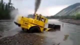 A Russian tractor driver refuses to give up after his vehicle gets stuck in a river.