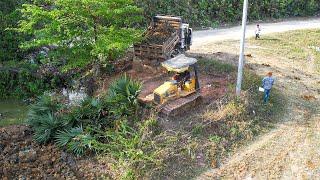 New Project Excellent By Dump Truck Dumping Soil On The Water With Small Dozer Pushing Dirt