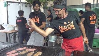 Salting a Big Grill of Ribs, Steaks and Sausages. Traditional Italian Street Food