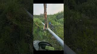 The Process Of Driving Poles Into The Ground With A Machine