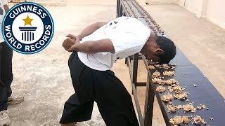 Most walnuts cracked against the head in one minute - Guinness World Records