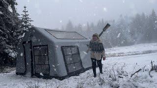 HOT TENT CAMP WITH A STOVE IN HEAVY SNOW