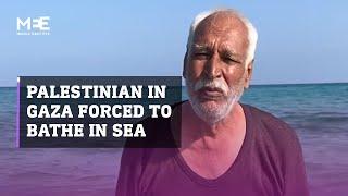 Palestinian man in Gaza forced to bathe in sea after being displaced