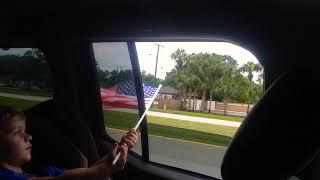 Roy Flies the U.S. Flag out the Car Window