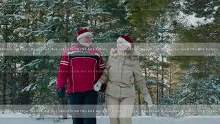 Couple in love walking on snowy forest at Christmas vacation. Happy man and woman walking on snowy