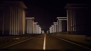 Restored floodgates by Studio Roosegaarde light up in the headlights of passing cars