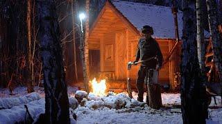 winter night in rustic log cabin during huge snowfall