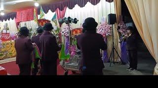 PLAYING THEIR HORNS AT THE BURIAL CEREMONY.