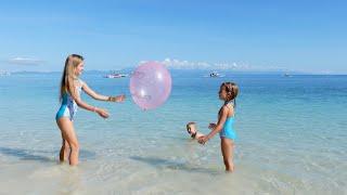Children playing on the beach with balloon 4K