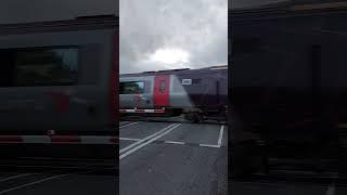 CrossCountry pass and barriers up at rural UK level crossing