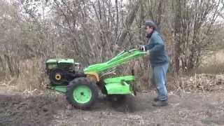 Diesel walk-behind tractor. Work cutter on solid ground.