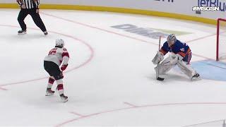 Jack Hughes scores a goal against the New York Islanders