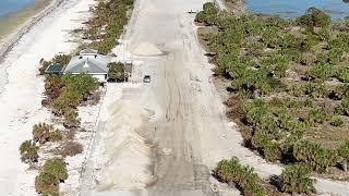 Crews working hard to clear lots of sand on Honeymoon Island parking lots from hurricanes 10/22/24