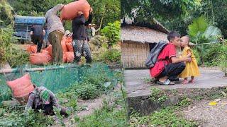 The boy went to school, the woman went to help them carry rice and they gave them bags of rice.