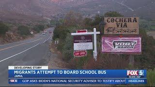 Migrants attempt to board school bus