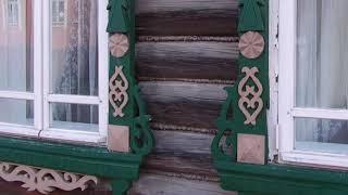 Russian traditions platbands carving in old houses under the music of russian gusli (psaltery)