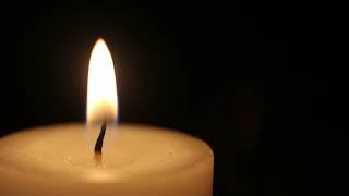 close up shot of a candle burning isolated on a black background 4uwerbisg  D