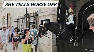 TOURIST TELLS HORSE OFF. OTHER WOMAN SENDS KISS TO KING'S GUARD at HORSE GUARDS in LONDON