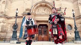 Roddy the Piper playing with under 18 world solo drumming champion Chloe Taylor