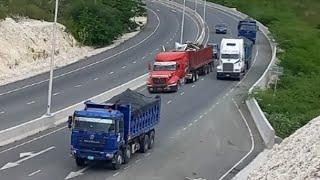 JAMAICAN EASTSIDE TRUCKERS  [AMERICAN TRUCKS AMBUSH BY CHINESE TRUCKS] UP STEEP HILL.