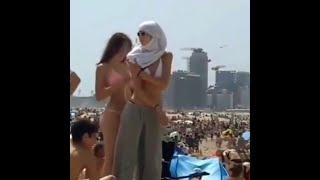 Hijabi girl walking on beach wearing bra  |  Arab girl walking on beach wearing bra