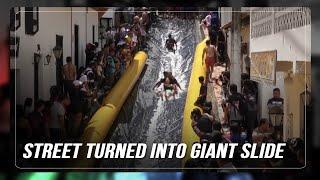 Colombian small village turns main street into giant slide | ABS-CBN News