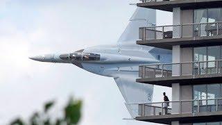 Crazy fighter jet pilot low pass between Australian city buildings