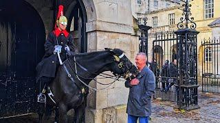 LADY GUARD SMILES AT TOURIST AFTER ORMONDE LUNGES AT HIS NECK at Horse Guards!