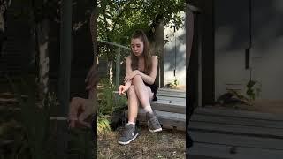 girl smoking on the bench outside and crush her cigarette