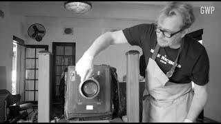 Gary Oldman takes a picture of Greg Williams on a vintage camera in his home studio