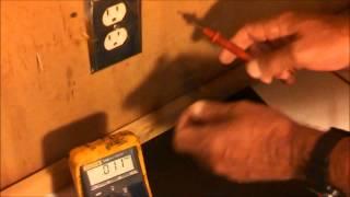 Using a multimeter to check an ac wall outlet