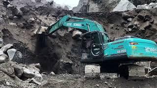 Large rocks collapsed as excavators dug into the sand cliffs