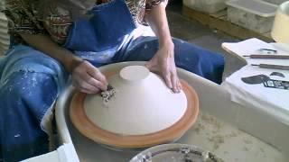 Trimming a wide rimmed Southern Ice porcelain bowl by Antoinette Badenhorst