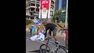 BICYCLE STUNT DURING PROTEST WITH ISRAELI FLAG