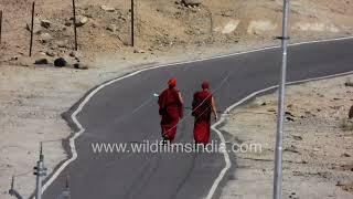 Indian Army Helicopter comes in to land around Leh in Ladakh, green Army Gypsy drives up the hill