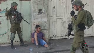 Israeli forces detain two Palestinian youths during clashes, in the West Bank city of Hebron