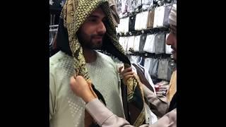 A man from Yemen demonstrates how to wear a Yemeni head scarf in Medina