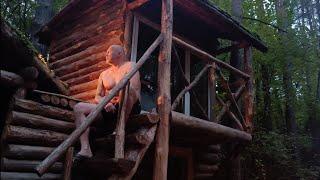 A man settled in a dense forest | Cooked potato pancakes with meat over a fire.