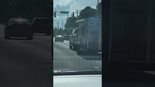 Food truck rolling down the road smoking with order window open