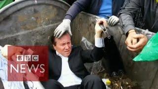 Ukrainian politician 'thrown' into a rubbish bin by angry mob - BBC News