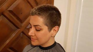 woman headshave blond long hair in barbershop by man