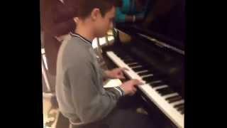 Cameron Dallas playing a piano