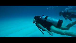 Scuba Diving Couple explore Undersea Realm