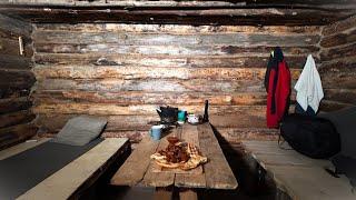 Alone in a Log Cabin in the Woods After a Snowfall. Winter Wilderness